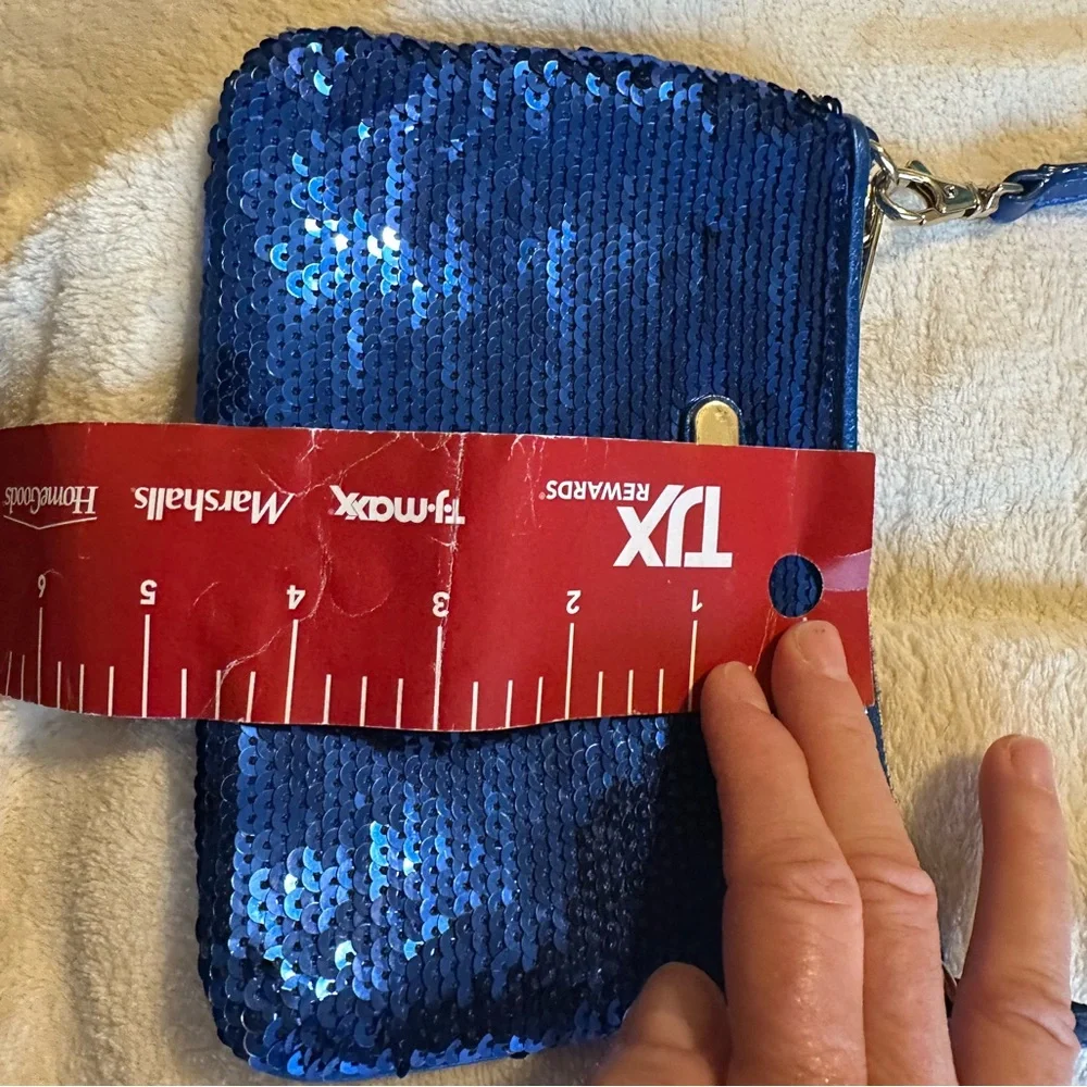Michael Kors sapphire blue sequined wristlet with gold colored hardware.